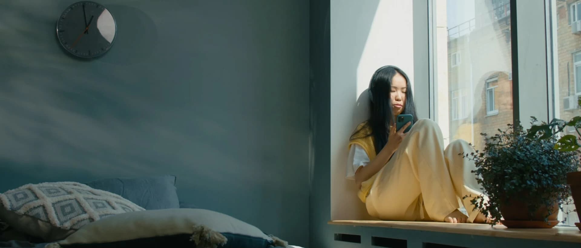 Woman sitting beside a sunlit window